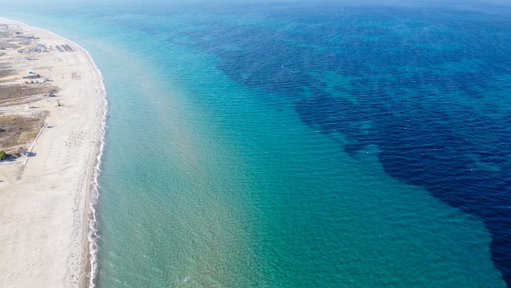 Hvor bør man bo på Kos? De 5 beste områdene & gode hoteller 3 Flyfoto av den lange sandstranden i Tigaki på Kos