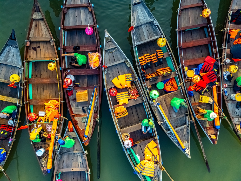 Trebåter på elva Thu Bon ved Gamlebyen i Hoi An